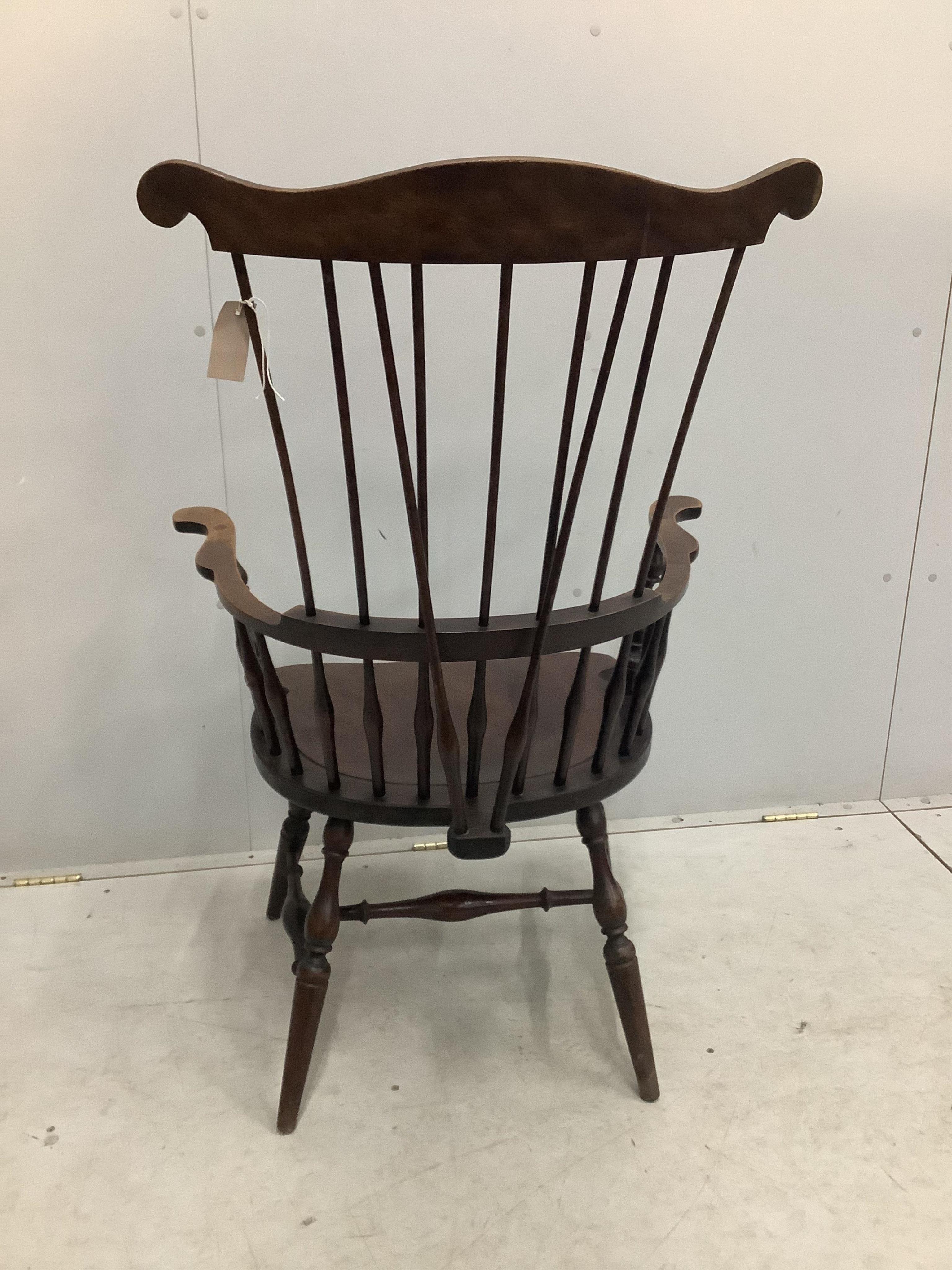 A 20th century American Windsor beech comb back armchair, width 73cm, depth 51cm, height 113cm. Condition - fair